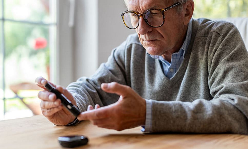 man testing blood sugar level with diabetes glucometer